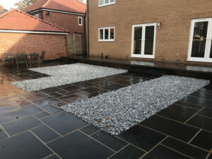 Black Limestone patio area with Ice Blue cobbles - Norwich